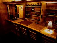 a bar with a table and chairs in a room at Villa Beskid in Milówka