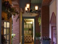 a room with a brick wall and a door with plants at DG Hotel in Taipei