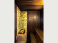 a hallway with a wooden door and a brick wall at Hotel Cassino Tower Campinas Cambuí By Nacional Inn in Campinas