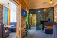 a restaurant with a table and chairs and a television at Rich OAK - готель з відкритим панорамний басейном in Yablunytsya