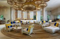 a lobby with couches and chairs in a building at Amari Phuket in Patong Beach