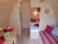a small room with two beds and a table at L&#39;Escale des Châteaux de la Loire in Angé