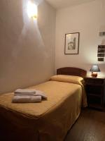 Łóżko lub łóżka w pokoju w obiekcie HG Hotel Italia