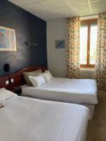 a hotel room with two beds and a window at Grand Hotel De La Poste - Lyon Sud - Vienne in Vienne