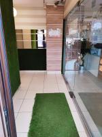 a hallway with a green rug in a store at Sophia Central Studio in Iaşi