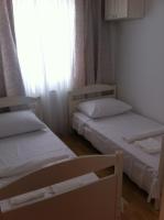 two beds in a small room with a window at Apartment Žarko in Brna