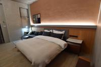 a bedroom with a large bed and a couch at Fu&#39;s house 52 in Tainan