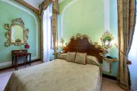 a bedroom with a large bed and a mirror at Hotel San Moisè in Venice