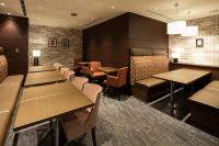 a restaurant with wooden tables and chairs and benches at HOTEL MYSTAYS Ueno East in Tokyo