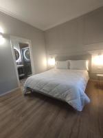a bedroom with a large white bed with two lamps at Residenza Montebello in Ancona