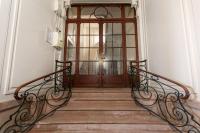 a set of stairs leading to a wooden door at L&#39;appart du galeriste 85m2 amazing view and space in Béziers