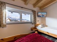 a bedroom with a bed and a window with mountains at Dani&#39;s Ferienwohnung in Söll