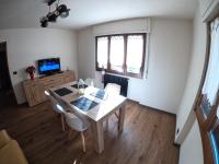 Televízia a/alebo spoločenská miestnosť v ubytovaní Baggio House