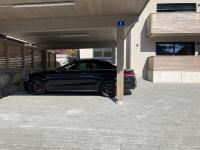 a black car parked under a parking garage at Apartment Das Georgen- Schmitten by Interhome in Fürstau