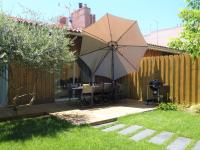 a patio with a table and an umbrella at Holiday Home Le Chant Des 4 Sirènes by Interhome in La Teste-de-Buch