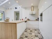 a kitchen with white cabinets and a tile floor at Holiday Home Le Chant Des 4 Sirènes by Interhome in La Teste-de-Buch