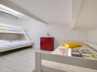 a bedroom with two bunk beds and a red cabinet at Holiday Home Le Chant Des 4 Sirènes by Interhome in La Teste-de-Buch