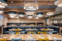 a large dining room with tables and chairs at Ramat Rachel Resort in Jerusalem