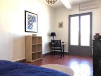 a bedroom with a bed and a chair and a window at L&#39;appart du galeriste 85m2 amazing view and space in Béziers