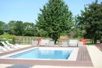 a swimming pool with white chairs and a table at Hostellerie de la Renaissance - Teritoria in Argentan