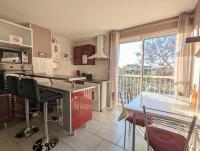 a kitchen with a glass table and a dining room at Appartement cosy avec parking proche port et plage in Cap d&#39;Agde