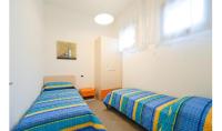 A bed or beds in a room at Condominio Quadrangolo-Gemini