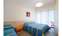 A bed or beds in a room at Condominio Quadrangolo-Gemini