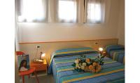 A bed or beds in a room at Condominio Quadrangolo-Gemini