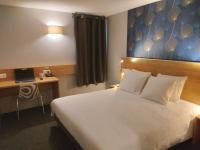 a hotel room with a bed and a desk with a laptop at Cit&#39;Hotel Hotel Prime - A709 in Saint-Jean-de-Védas
