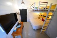 a small room with a bunk bed and a desk at 安蘭居旅店 An Lan Jie Hotel in Chiayi City