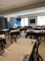 a dining room filled with tables and chairs at Hotel Bussana in Porto Tolle