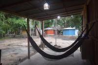 a hammock hanging from a building in a room at Pousada Grão in Belém