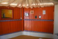 a room with red wood paneled walls with signs on it at Pousada Grão in Belém