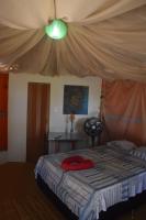 a bedroom with a bed with a canopy at Pousada Grão in Belém