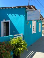 a blue building with a sign on it at Villa Maragogi Hostel in Maragogi