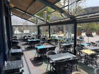 a restaurant with tables and chairs inside of a building at Hôtel France et Chateaubriand in Saint Malo