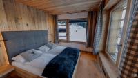 A bed or beds in a room at Rufana Alpsuite