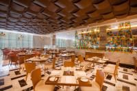 a restaurant with tables and chairs and a bar at Moon Palace The Grand Cancun All Inclusive in Cancún