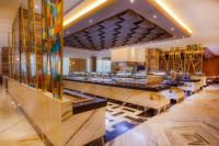 a lobby with a bar with stained glass windows at Moon Palace The Grand Cancun All Inclusive in Cancún