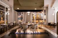 um restaurante com fogueira no meio do quarto em Grand Hotel Vilnius, Curio Collection by Hilton em Vilnius