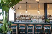 a bar with chairs at a restaurant with a counter at The Hoxton, Downtown LA in Los Angeles