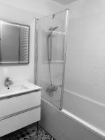 a white bathroom with a shower and a sink at House with garden Disneyland Paris in Magny-le-Hongre