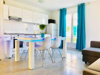 a kitchen with a blue table and white chairs at House with garden Disneyland Paris in Magny-le-Hongre