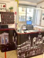 an office with a desk with a picture of a building at Hôtel Colisée-Verdun Centre Gare Saint-Roch in Montpellier