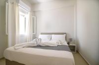 Postel nebo postele na pokoji v ubytování De_naxia Suites