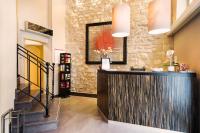 a bar in a lobby with a stone wall at Arc Elysées in Paris