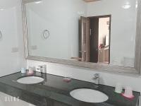a bathroom with two sinks and a large mirror at Happy Life B&amp;B in Donggang