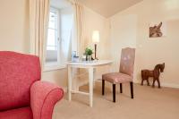 a living room with a table and a chair and a horse statue at Kino-Hotel Meyer in Harsefeld