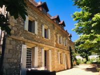 an old brick building with a gate in front at Manoir du Bois Mignon in Le Fleix