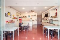 a kitchen and dining room with tables and chairs at Moonlake B&amp;B in Yuchi